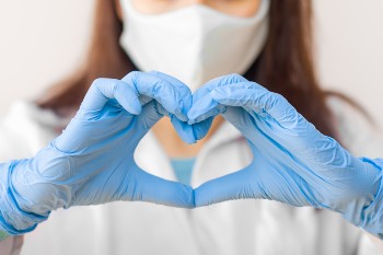 Doctor making a heart with her hands