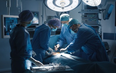 Doctors performing surgery in an operating room